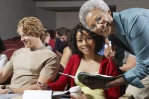 Teachers are studying in a professional development program.