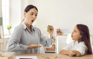 Teacher doing exercises with a kid on phonemic awareness