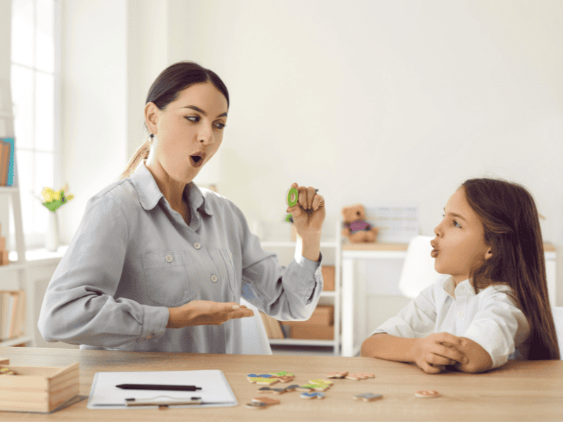 Teacher doing exercises with a kid on phonemic awareness